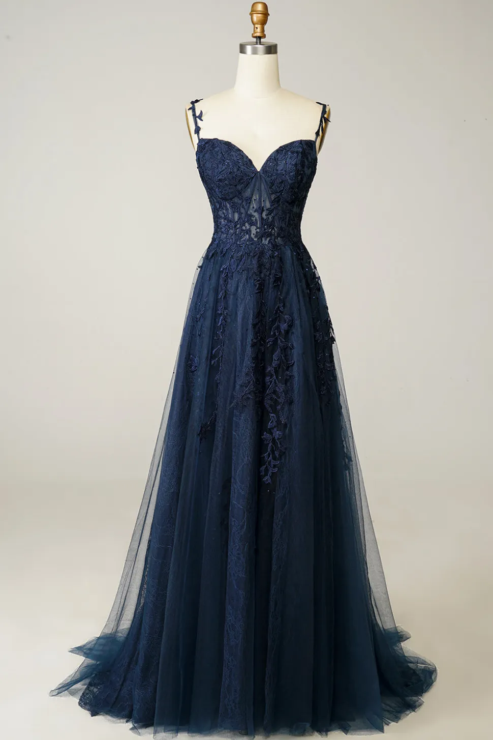 Um vestido de baile spaghetti de linha com apliques