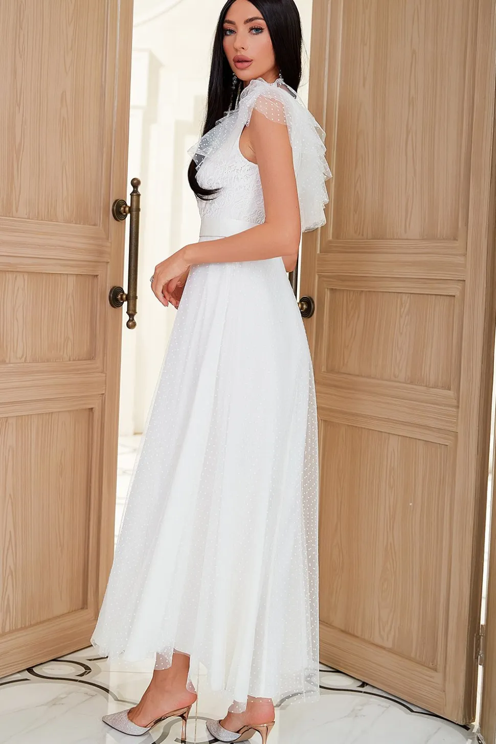 Um vestido de festa branco de ombro com fio de rede