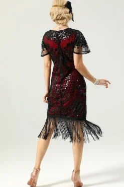 Vestido preto e dourado de 1920 com mangas de batwing